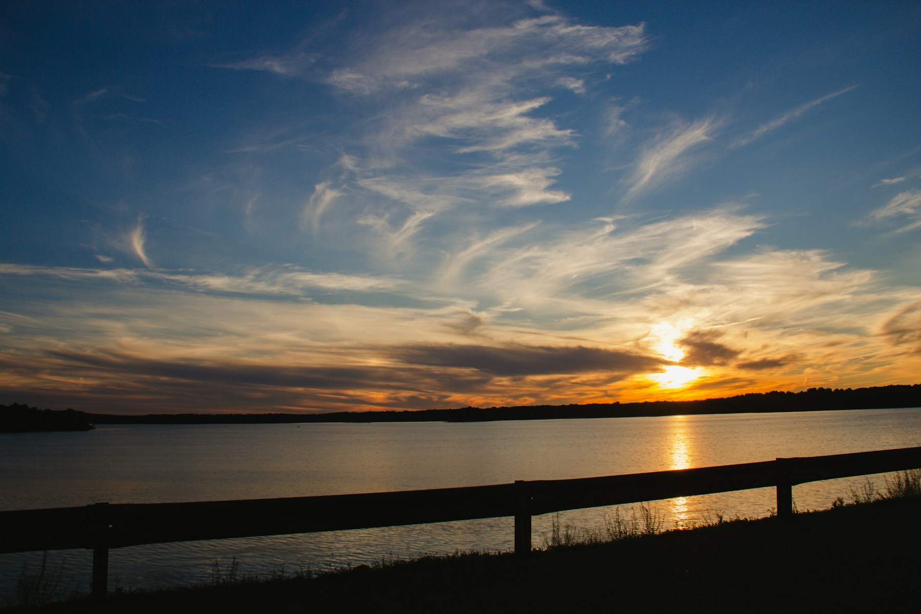 Sunlight glowing across the water at the end of a lake day
